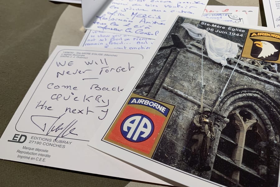 In this Tuesday, Dec. 15, 2020 photo, A handwritten post card from a resident of Sainte-Mere-Eglise, France thanks U.S. paratroopers for liberating their village from Nazi occupation, seen at Fort Bragg, N.C. The town sent 500 notes to Fort Bragg, North Carolina which were read by soldiers. 12,000 82nd paratroopers fought to liberate Normandy on June 6th, 1944. 1,400 were lost their lives in the invasion.