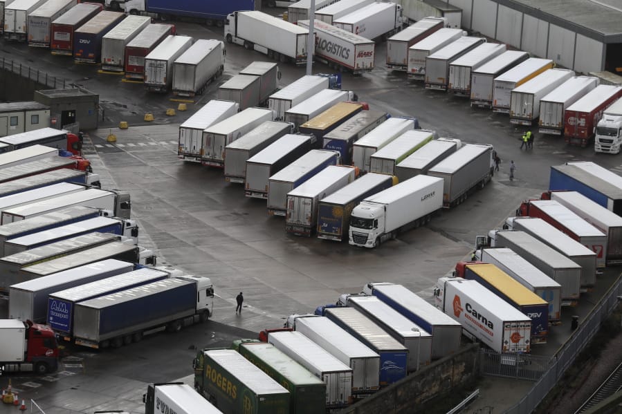 Trucks are parked in Dover, whilst the Port remains closed, in Kent, England, Tuesday, Dec. 22, 2020. Trucks waiting to get out of Britain backed up for miles and people were left stranded at airports as dozens of countries around the world slapped tough travel restrictions on the U.K. because of a new and seemingly more contagious strain of the coronavirus in England.