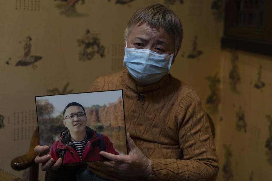 Zhong Hanneng holds a photo of her son, Peng Yi, and talks about his difficulties in getting tested for COVID-19, eventually dying from the disease, in Wuhan in central China&#039;s Hubei province on Saturday, Oct. 17, 2020. &quot;There were very, very few tests, basically none. ... if you couldn&#039;t prove you were positive, you couldn&#039;t get admitted to a hospital. ...