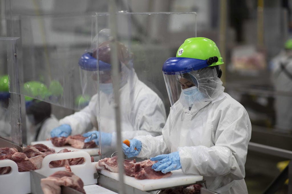 This May 20, 2020, photo provided by Smithfield Foods shows some of the measures the company says it has taken to limit the spread of the coronavirus inside its plants.