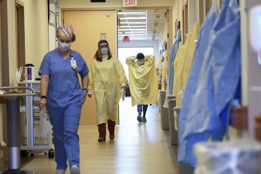 Nurses and medical staff make their way through the seventh floor COVID-19 unit at East Alabama Medical Center Thursday, Dec. 10, 2020, in Opelika, Ala. COVID-19 patients occupy most of the beds in ICU in addition to the non-critical patients on the seventh floor.