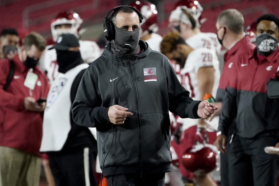 Washington State head coach Nick Rolovich walks the sideline during the second half of an NCAA college football game against Southern California in Los Angeles, Sunday, Dec. 6, 2020.
