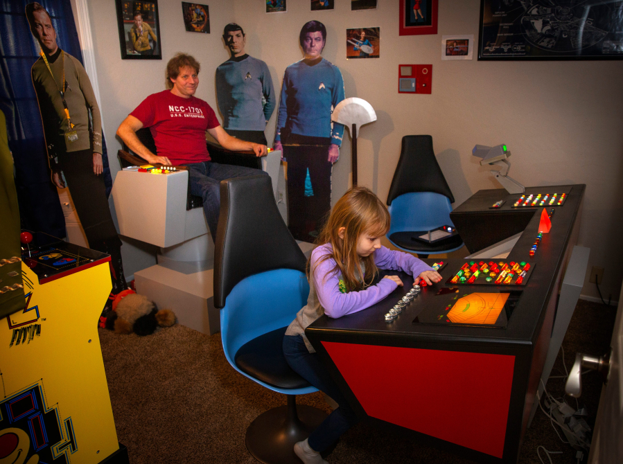 Allan Quick takes in the view from the Captain&amp;#39;s Chair, at left, while daughter Rachel Quick, 8, plays at the navigation console of a replica of the bridge of the USS Enterprise from the 1966 television show &amp;#34;Star Trek&amp;#34; that he created in their Eugene home.