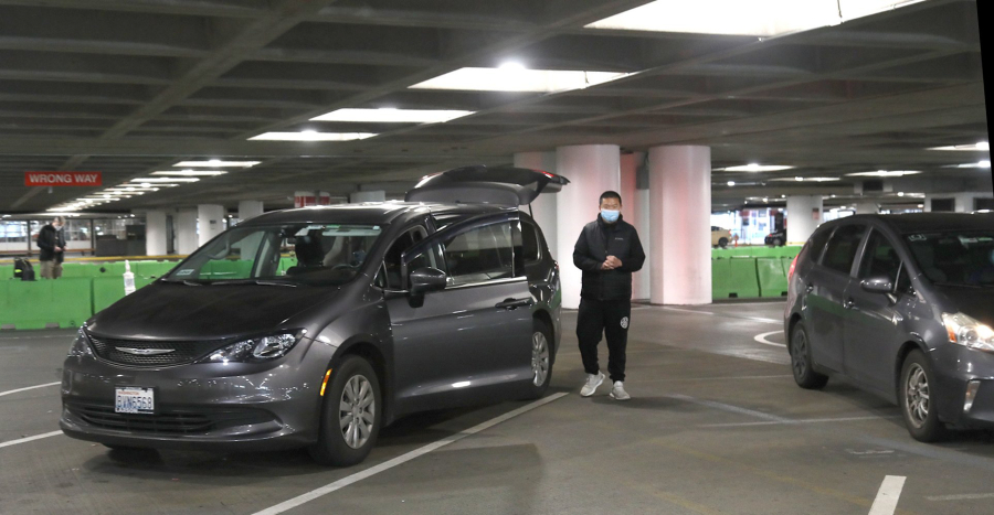 Uber driver Victor Gao waits for a rider Dec. 23 in the parking garage at Seattle-Tacoma International Airport.