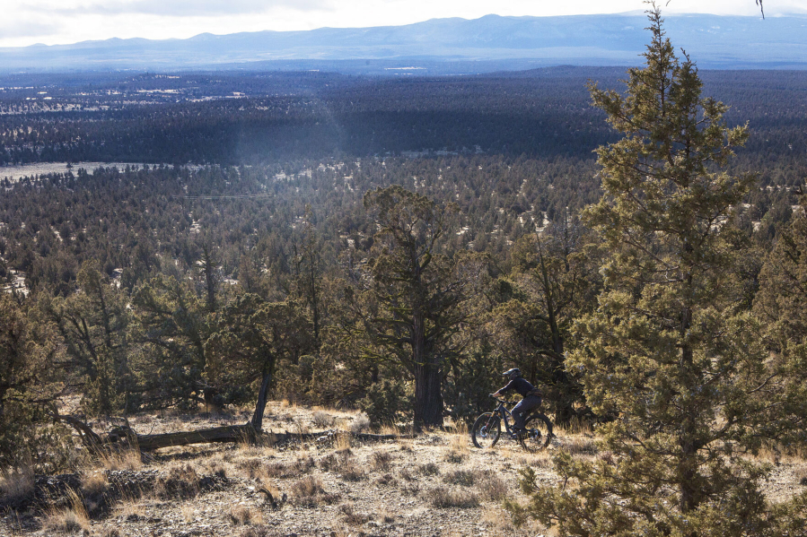 A mountain biker rides down a singletrack trail at Cline Buttes on Saturday, Dec. 26, 2020.