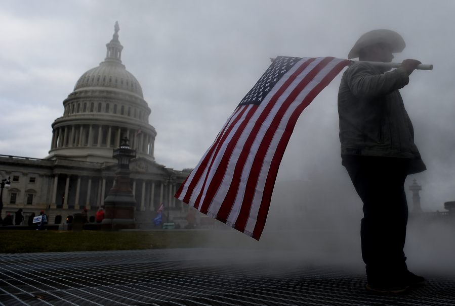 Supporters of US President Donald Trump hold a rally outside the US Capitol as they protest the upcoming electoral college certification of Joe Biden as President in Washington, DC on Jan. 6, 2021.