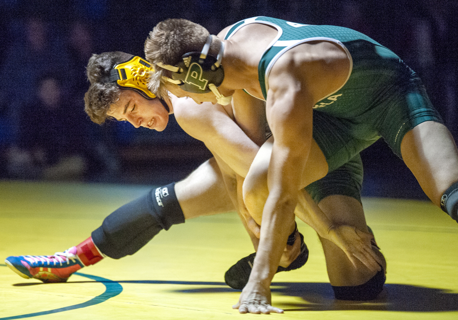 Heritage&#039;s Alex Newberry, left, wrestles at the Pacific Coast Championships in Dec. 2019. An amendment proposed by Heritage wrestling coach Erik Gonzalez would make such two-day tournaments count as one of a wrestling team&#039;s 16 allowed team events.