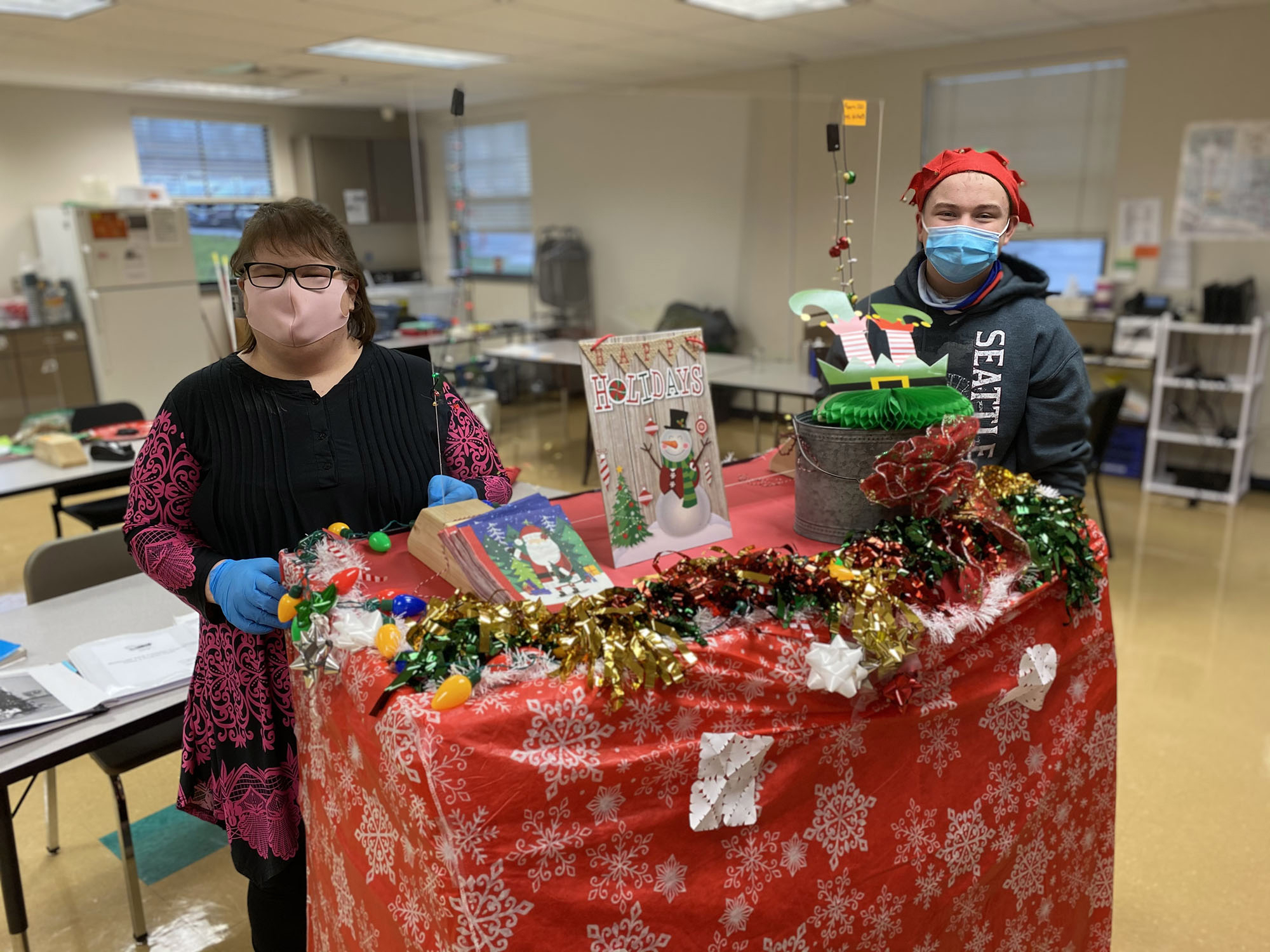 WASHOUGAL: Tiffaney Forney, Washougal Adult Transition Program job coach and Washougal High School freshman Blake Early prepare to roll holiday treats out to teachers.