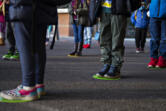 Kindergartners and first-graders at Crestline Elementary School line up on their spot while social distancing before class on Tuesday morning, January 19, 2021.