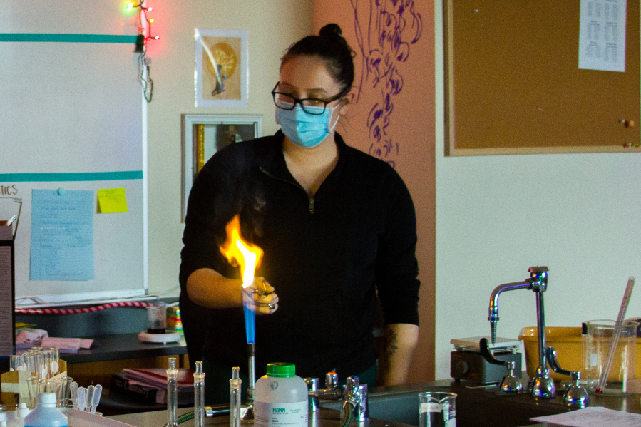 WOODLAND: Stephanie Marshall, a high school science teacher, lights magnesium on fire to demonstrate chemical reactions during a recent virtual science lab.