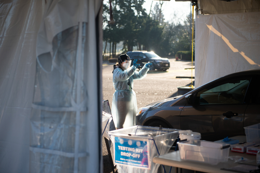 Staffer Allison Berhow instructs a driver to self-administer an oral COVID-19 test Saturday at the new Tower Mall drive-thru testing site. Visitors receive their results in two or three days.