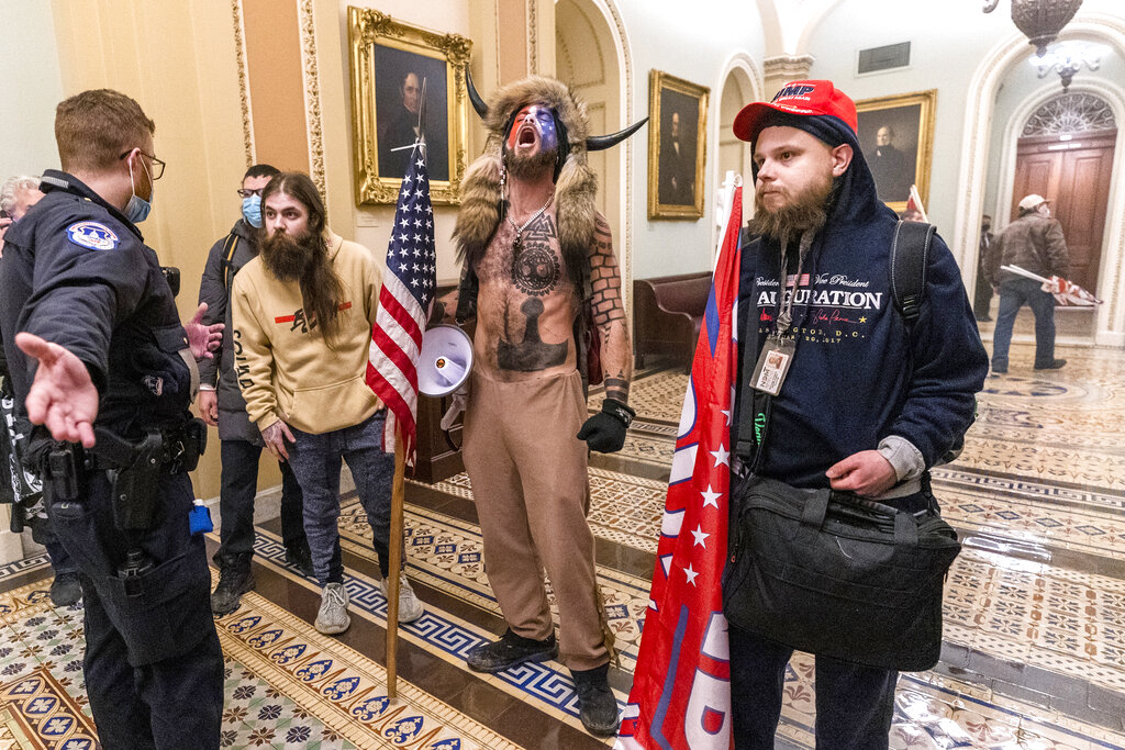 Supporters of President Donald Trump are confronted by Capitol Police officers outside the Senate Chamber inside the Capitol, Wednesday, Jan. 6, 2021 in Washington.