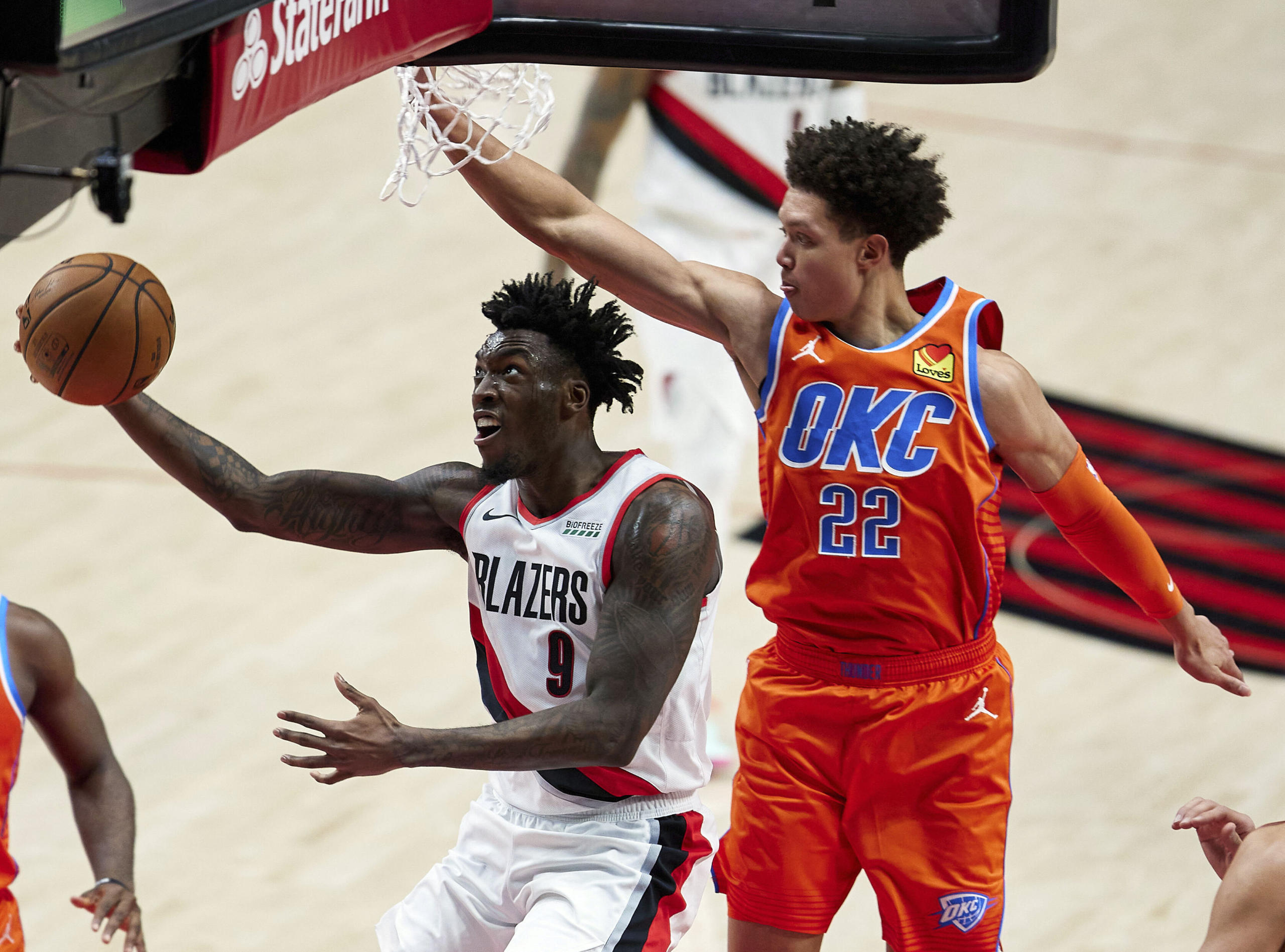 Portland Trail Blazers forward Nassir Little, left, shoots in front of Oklahoma City Thunder forward Isaiah Roby during the first half of an NBA basketball game in Portland, Ore., Monday, Jan. 25, 2021.