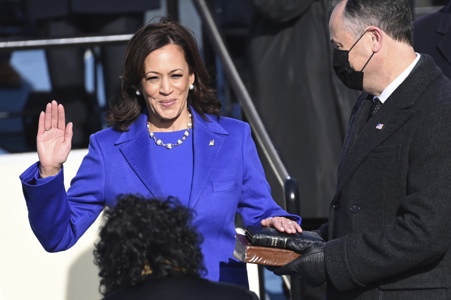 Kamala Harris is sworn in as vice president by Supreme Court Justice Sonia Sotomayor as her husband Doug Emhoff holds the Bible during the 59th Presidential Inauguration at the U.S. Capitol in Washington, Wednesday, Jan.