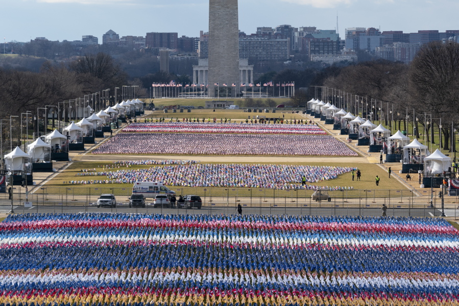 Flags are placed on the National Mall, looking towards the Washington Monument, and the Lincoln Memorial, ahead of the inauguration of President-elect Joe Biden and Vice President-elect Kamala Harris, Monday, Jan. 18, 2021, in Washington.