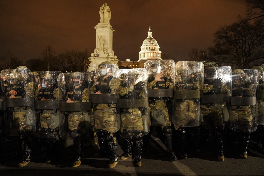 District of Columbia National Guard stand outside the Capitol, Wednesday night, Jan. 6, 2021, after a day of rioting protesters. It&#039;s been a stunning day as a number of lawmakers and then the mob of protesters tried to overturn America&#039;s presidential election, undercut the nation&#039;s democracy and keep Democrat Joe Biden from replacing Trump in the White House.