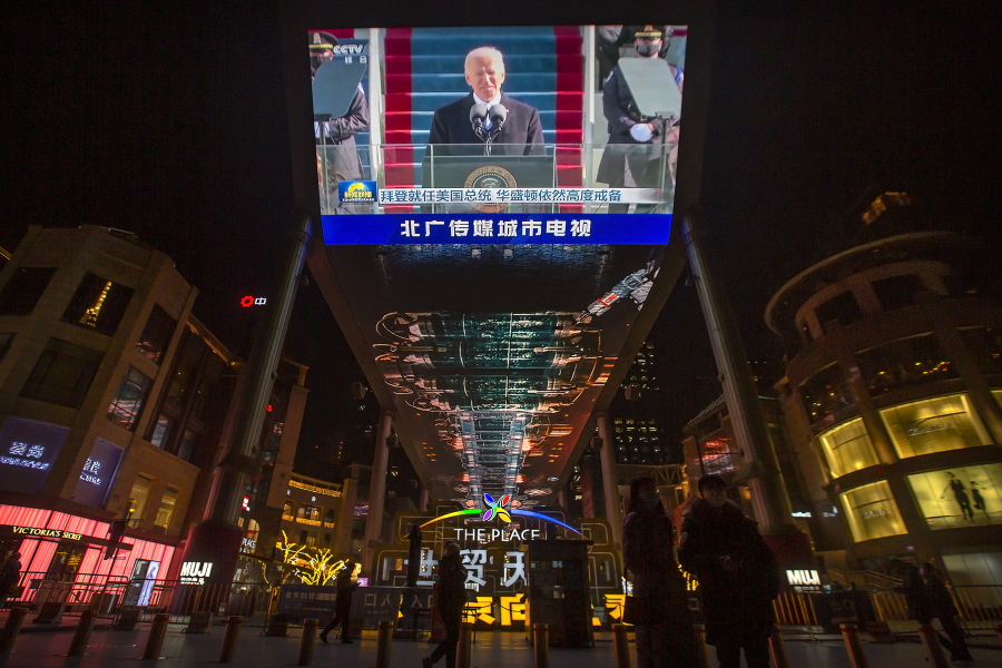 A large video screen shows a government news report about the inauguration of President Joe Biden at a shopping mall in Beijing, Thursday, Jan. 21, 2021. China has expressed hope the Biden administration will improve prospects for people of both countries and give a boost to relations after an especially rocky patch, while getting in a few final digs at former Trump officials.