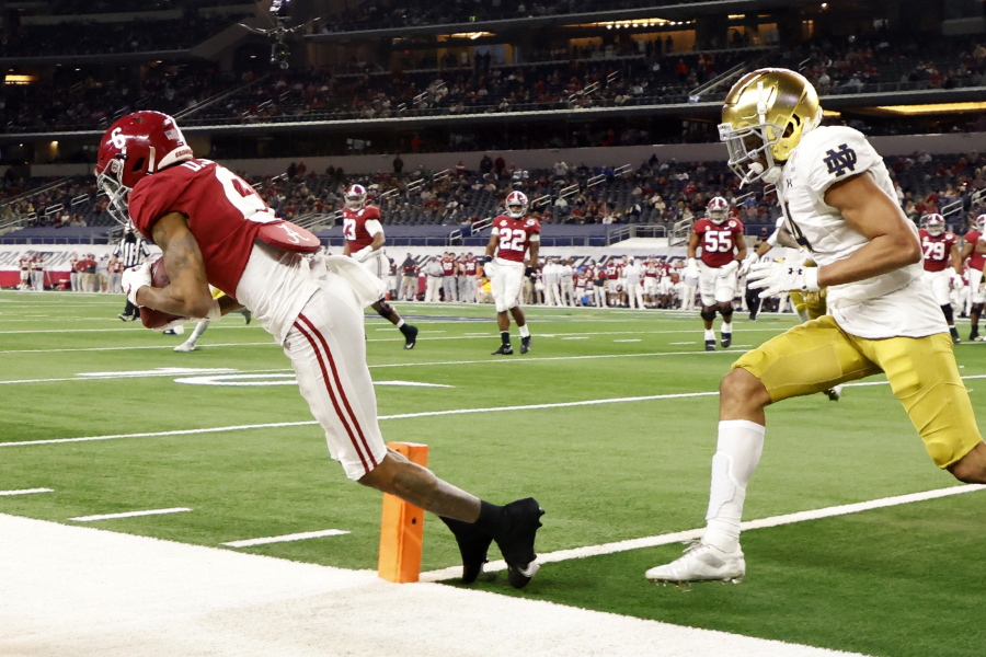 Alabama wide receiver DeVonta Smith (6) catches a pass in the end zone for a touchdown as Notre Dame cornerback Nick McCloud, right, defends in the second half of the Rose Bowl NCAA college football game in Arlington, Texas, Friday, Jan. 1, 2021.
