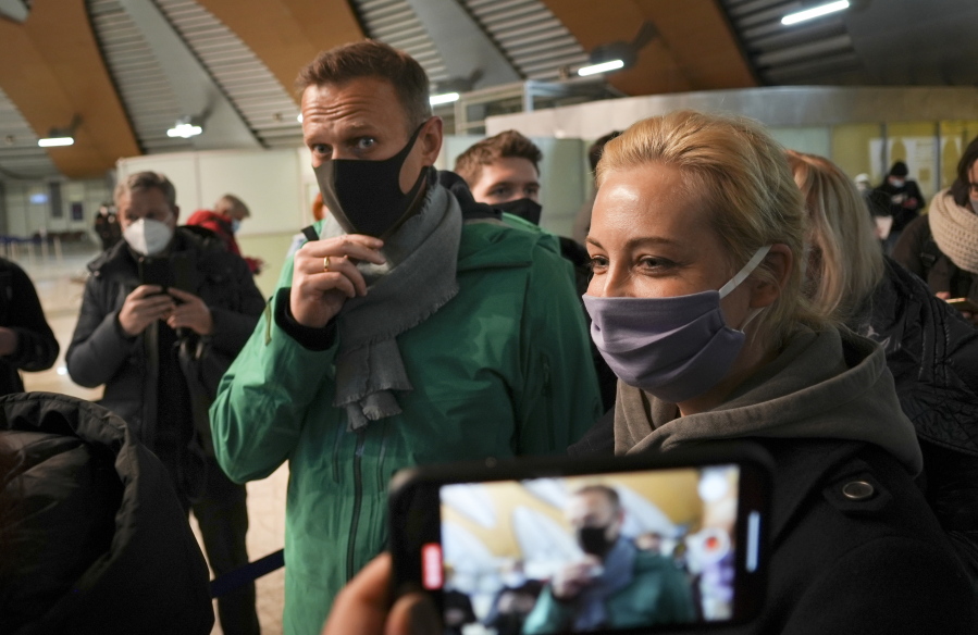 Alexei Navalny and his wife Yuliastand in line at the passport control after arriving at Sheremetyevo airport, outside Moscow, Russia, Sunday, Jan. 17, 2021. Russia&#039;s prison service says opposition leader Alexei Navalny has been detained at a Moscow airport after returning from Germany.