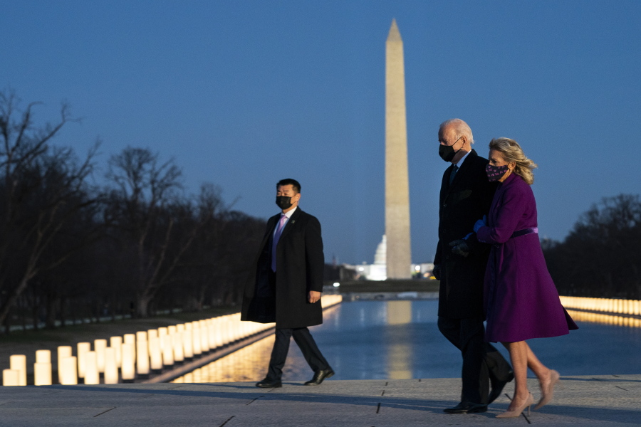 President-elect Joe Biden and his wife Jill Biden leave a COVID-19 memorial event at the Lincoln Memorial Reflecting Pool, Tuesday, Jan. 19, 2021, in Washington.