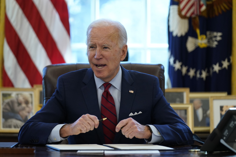 President Joe Biden signs a series of executive orders on health care, in the Oval Office of the White House, Thursday, Jan. 28, 2021, in Washington.