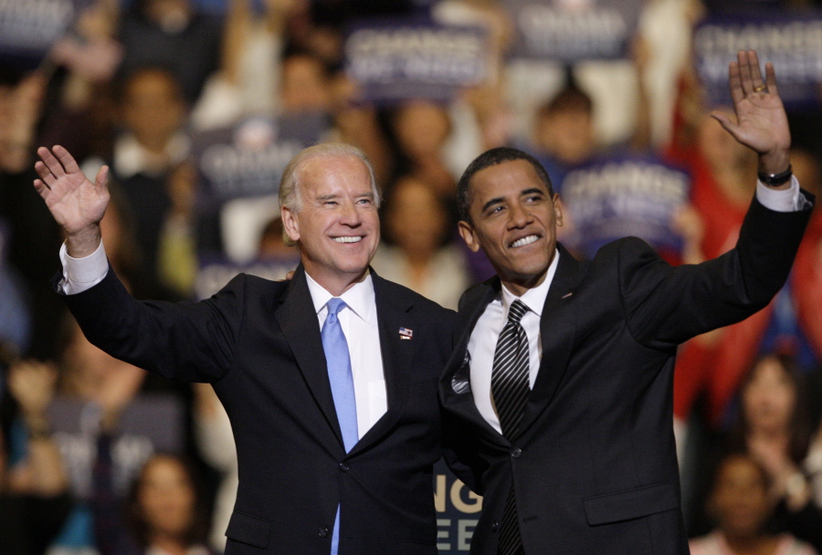 FILE - In this Oct. 29, 2008, file photo Vice presidential candidate Joe Biden, D-Del., left, and Democratic presidential candidate Sen. Barack Obama, D-Ill., right, wave during a rally at the Bank Atlantic Center in Sunrise, Fla.