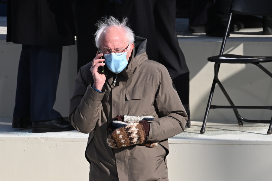 Vermont Senator Bernie Sanders wore his signature beige parka with patterned mittens.