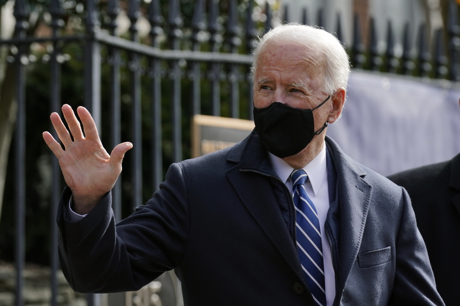 President Joe Biden waves as he departs after attending Mass at Holy Trinity Catholic Church, Sunday, Jan. 24, 2021, in the Georgetown neighborhood of Washington. Biden plans to sign an executive order Monday, Jan. 25 that aims to boost government purchases from U.S. manufacturers.