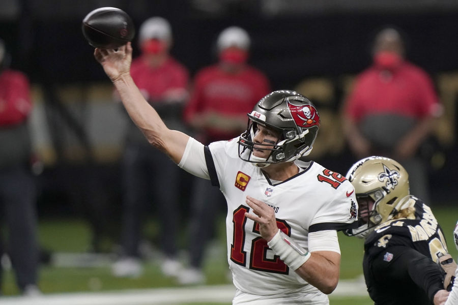 Tampa Bay Buccaneers quarterback Tom Brady (12) works against the New Orleans Saints during the first half of an NFL divisional round playoff football game, Sunday, Jan. 17, 2021, in New Orleans.