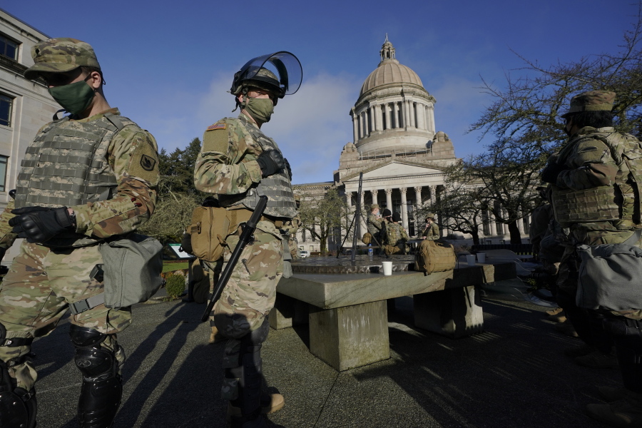 Members of the Washington National Guard stand at a sundial near the Legislative Building, Sunday, Jan. 10, 2021, at the Capitol in Olympia, Wash. Governors in some states have called out the National Guard, declared states of emergency and closed their capitols over concerns about potentially violent protests. Though details remain murky, demonstrations are expected at state capitols beginning Sunday and leading up to President-elect Joe Biden&#039;s inauguration on Wednesday. (AP Photo/Ted S.