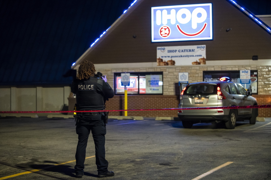 Chicago and Evanston police investigate the scene of a shooting outside an IHOP restaurant in Evanston, Ill., Saturday night, Jan. 9, 2020.