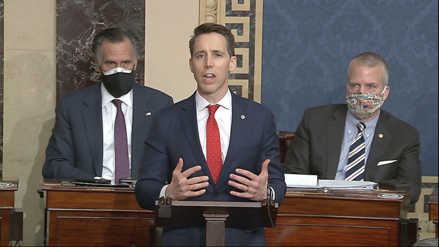 In this image from video, Sen. Josh Hawley, R-Mo., speaks as the Senate reconvenes to debate the objection to confirm the Electoral College Vote from Arizona, after protesters stormed into the U.S. Capitol on Wednesday, Jan. 6, 2021.