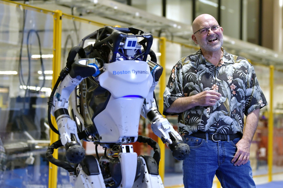 Marc Raibert, founder and chair of Boston Dynamics stands beside one of the company&#039;s Atlas robots during an interview and demonstration, Wednesday, Jan. 13, 2021, at their facilities in Waltham, Mass. The company engineered the robot to be able to dance in a fluid manner that is almost human.