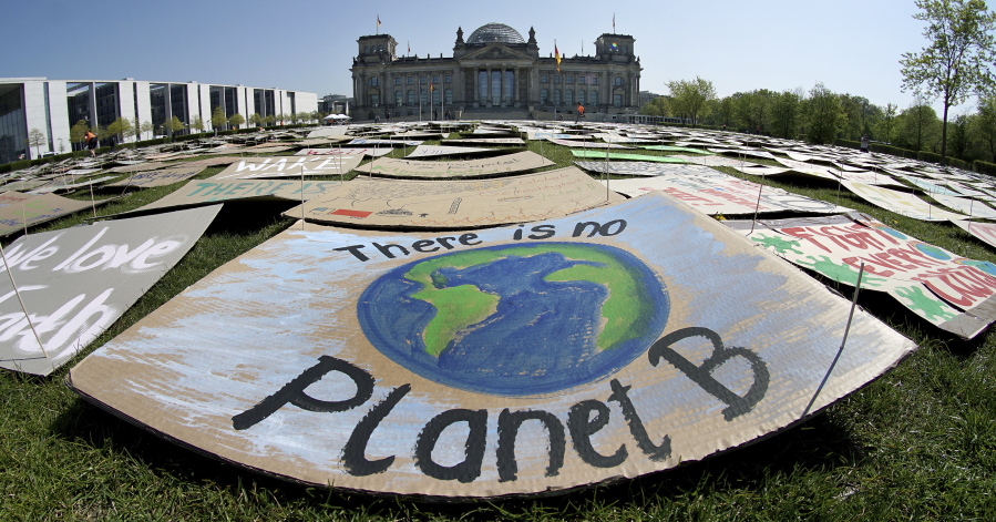 In this Friday, April 24, 2020 file photo, activists place thousands of protest placards in front of the Reichstag building, home of the german federal parliament, Bundestag, during a protest rally of the &#039;Fridays for Future&#039; movement in Berlin, Germany. World leaders breathed an audible sigh of relief that the United States under President Joe Biden is rejoining the global effort to curb climate change, a cause that his predecessor had shunned.