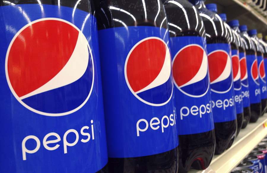 FILE - In this July 9, 2015, file photo, Pepsi bottles are on display for sale at a supermarket in Haverhill, Mass. PepsiCo Inc. reports earnings, Wednesday, Oct. 4, 2017. PepsiCo, which makes Frito Lay chips and Quaker cereals, is getting a boost as more U.S. consumers eat breakfast and snack at home. The Purchase, New York-based company said Tuesday, April 28, 2020, that its organic sales grew 7.9% in the first quarter.