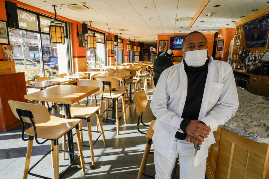 Andrew Walcott, owners of Fusion East Caribbean &amp; Soul Food restaurant, poses for a photo at the restaurant in East New York neighborhood of the Brooklyn borough of New York, Thursday, Jan. 7, 2021.  Walcott had to furlough four employees at his restaurant just before Christmas, after New York state stopped allowing indoor dining.