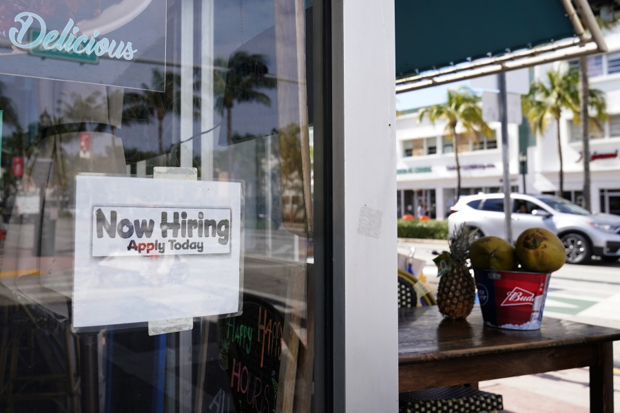 A &quot;Now Hiring,&quot; sign is shown in the window of a restaurant, Thursday, Jan. 7, 2021, in Miami Beach, Fla. America&#039;s employers likely cut back on hiring last month, and may have even shed jobs, as the economy suffers from a resurgent virus that has caused many consumers to cut back on spending and states and cities to reimpose business restrictions.