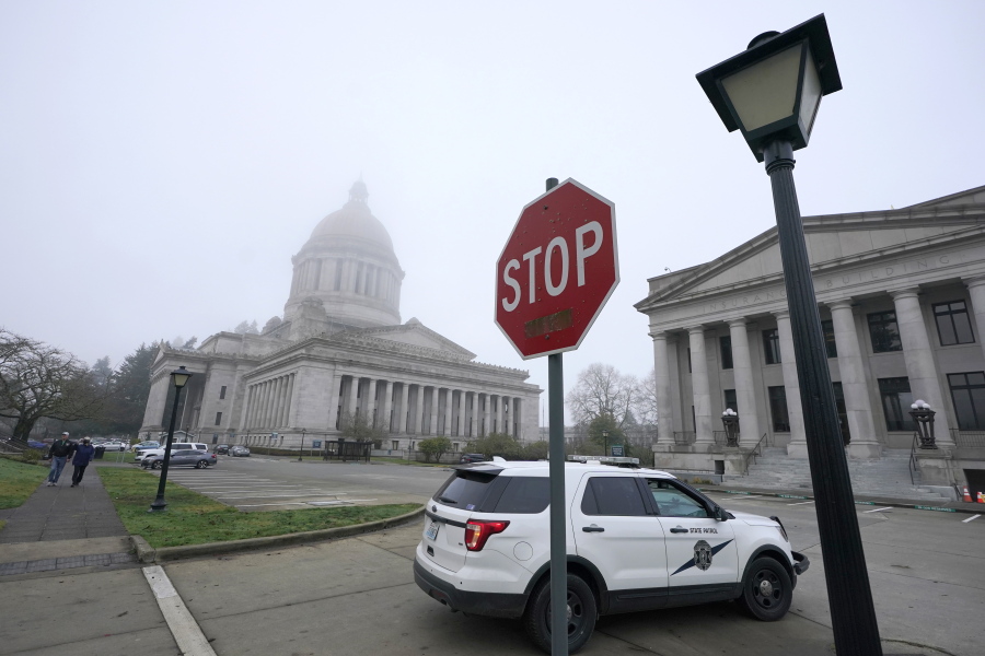 A Washington State Patrol vehicle patrols Thursday, Jan. 7, 2021, at the Capitol in Olympia. (AP Photo/Ted S.
