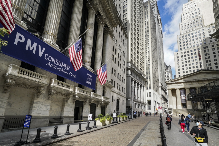 FILE - In this Oct. 2, 2020 file photo, pedestrians pass the New York Stock Exchange in New York.  Stocks are off to a strong start on Wall Street, Tuesday, Jan. 26, 2021, as the market finds its bearings following a bumpy ride a day earlier.