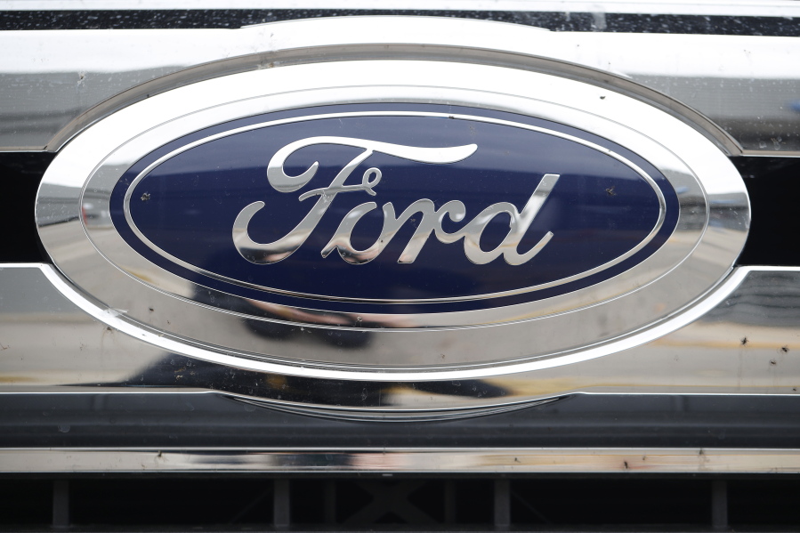 FILE - In this Oct. 20, 2019, file photograph, the company logo shines off the grille of an unsold 2019 F-250 pickup truck at a Ford dealership in Littleton, Colo. Ford Motor Co. posted a stronger-than-expected third-quarter net profit, the company announced Wednesday, Oct. 28, 2020, as demand for cars and trucks recovered from coronavirus shutdowns and the company sold more high-margin trucks.
