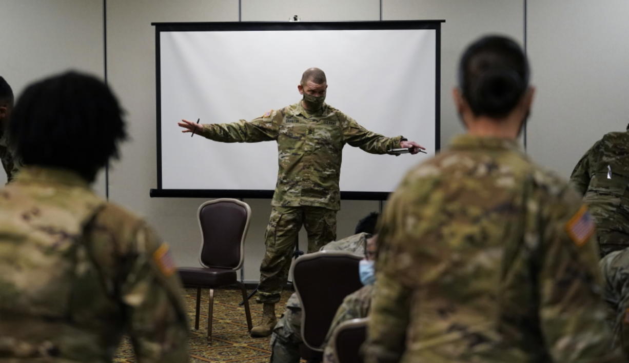 Sergeant Major of the Army Michael Grinston, center, gets feedback from soldiers about their concerns at Fort Hood, Texas, Thursday, Jan. 7, 2021. Following more than two dozen soldier deaths in 2020, including multiple homicides, the U.S. Army Base is facing an issue of distrust among soldiers.