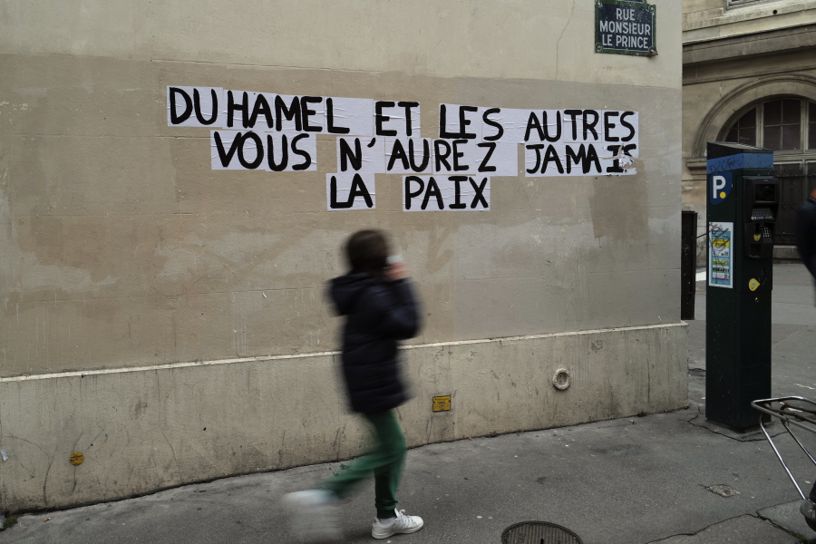 Signs on the wall reads &quot;Duhamel, and the others, you will never be in peace&quot; referring to prominent French political expert, Olivier Duhamel, in Paris, Tuesday, Jan. 19, 2021. The French government pledged on Thursday to toughen laws on the rape of children, as a massive online movement has seen hundreds of victims share accounts about sexual abuses within their families under the hashtag #MeTooInceste.