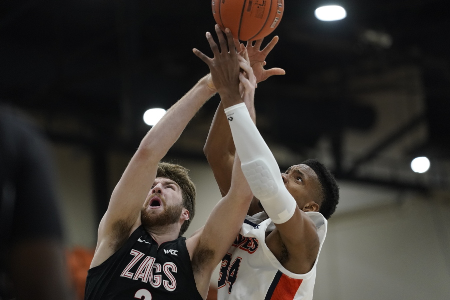 Gonzaga forward Drew Timme, left, and Pepperdine center Victor Ohia Obioha (34) reach for a rebound during the first half of an NCAA college basketball game Saturday, Jan. 30, 2021, in Malibu, Calif.