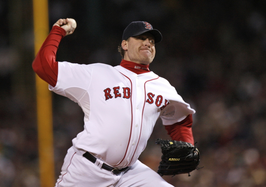 FILE - In this Oct. 25, 2007, file photo, Boston Red Sox&#039;s Curt Schilling pitches against the Colorado Rockies in Game 2 of the baseball World Series at Fenway Park in Boston. Like many baseball writers, C. Trent Rosecrans viewed the Hall of Fame vote as a labor of love. The results of the 2021 vote will be announced Tuesday, Jan. 26, 2021, and Rosecrans was not alone in finding the task particularly agonizing this time around. With Schilling&#039;s candidacy now front and center -- and Barry Bonds and Roger Clemens still on the ballot as well -- voters have had to consider how much a player&#039;s off-field behavior should affect his Hall of Fame chances.