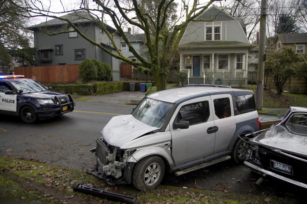Wrecked vehicles are seen after a driver struck and injured at least five people over a 20-block stretch of Southeast Portland, Ore., before crashing and fleeing on Monday, Jan. 25, 2021, according to witnesses.