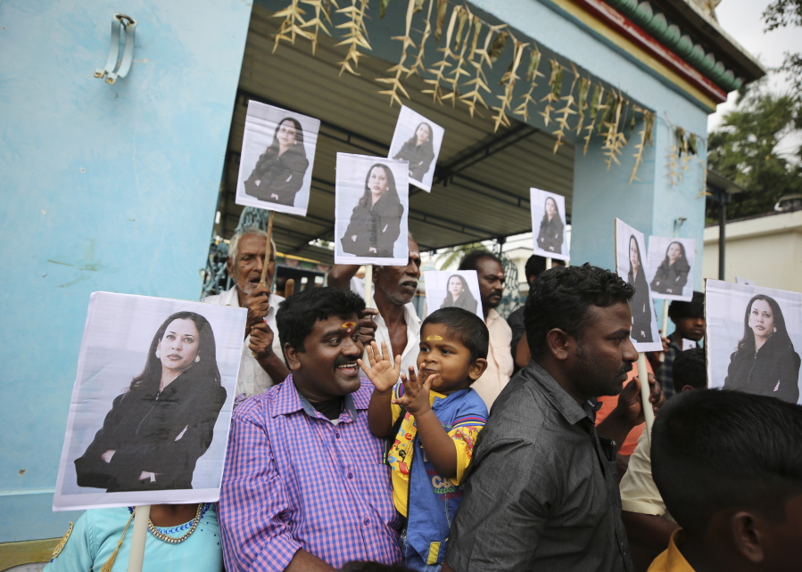 A child reacts as villagers hold placards featuring U.S. Vice President-elect Kamala Harris after participating in special prayers ahead of her inauguration, outside a Hindu temple in Thulasendrapuram, the hometown of Harris&#039; maternal grandfather, south of Chennai, Tamil Nadu state, India, Wednesday, Jan. 20, 2021. A tiny, lush-green Indian village surrounded by rice paddy fields was beaming with joy Wednesday hours before its descendant, Kamala Harris, takes her oath of office and becomes the U.S. vice president.