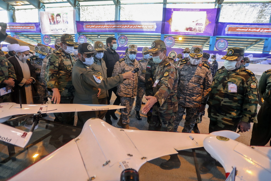 In this photo released Tuesday, Jan. 5, 2021 by the Iranian army, Chief of the General Staff of the Armed Forces Gen. Mohammad Hossein Bagheri, center, listens to an explanation while visiting at a display of drones prior to a drill, Iran. The Iranian military on Tuesday began a wide-ranging, two-day aerial drill in the country&#039;s north, state media reported, featuring combat and surveillance unmanned aircraft, as well as naval drones dispatched from vessels in Iran&#039;s southern waters.