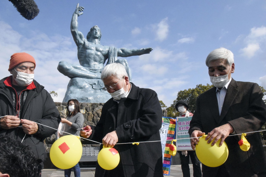 Participants deflate balloons in hope of neutralizing and demolishing nuclear warheads, during a memorial gathering at Peace Park in Nagasaki, southern Japan Friday, Jan. 22, 2021. The first-ever treaty to ban nuclear weapons entered into force on Friday, hailed as a historic step to rid the world of its deadliest weapons but strongly opposed by the world&#039;s nuclear-armed nations.
