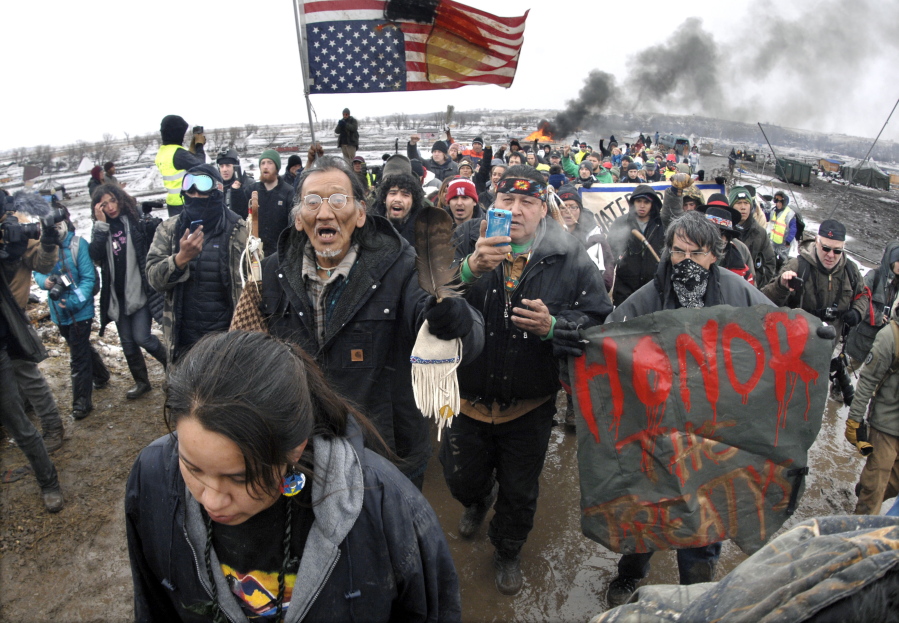 FILE - In this Feb. 22, 2017, file photo, a large crowd representing a majority of the remaining Dakota Access Pipeline protesters march out of the Oceti Sakowin camp near Cannon Ball, N.D. After President Joe Biden revoked Keystone XL&#039;s presidential permit and shut down construction of the long-disputed pipeline that was to carry oil from Canada to Texas, opponents of other pipelines hoped the projects they&#039;ve been fighting would be next.