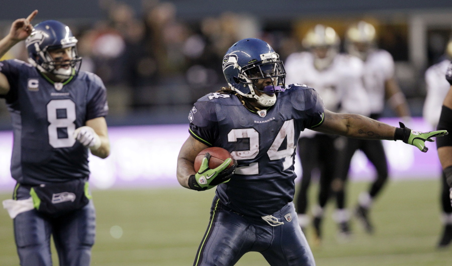 Seattle Seahawks&#039; Marshawn Lynch begins to celebrate after a 67-yard touchdown run against the New Orleans Saints on Jan. 8, 2011, in Seattle.